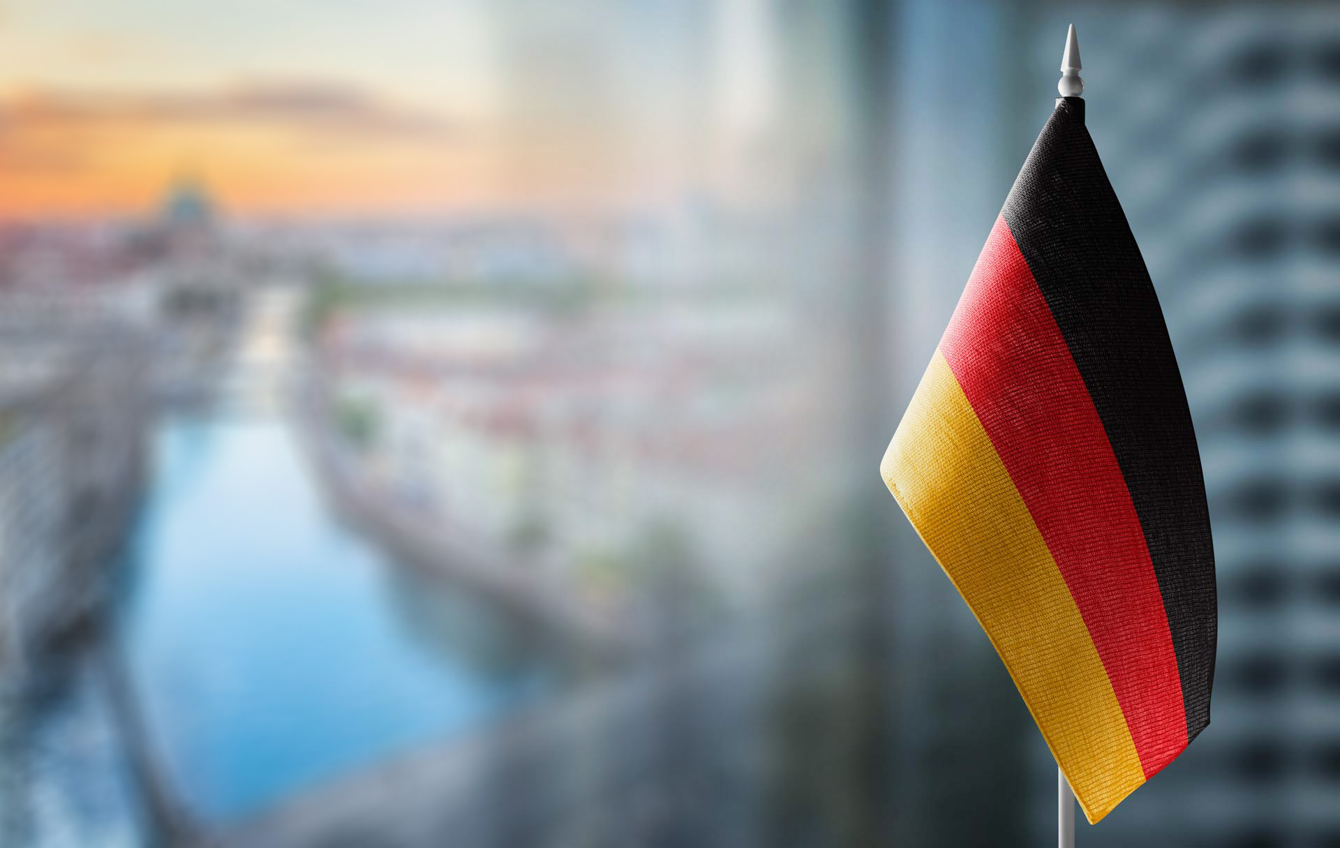 small-flag-germany-blurred-cityMIXED